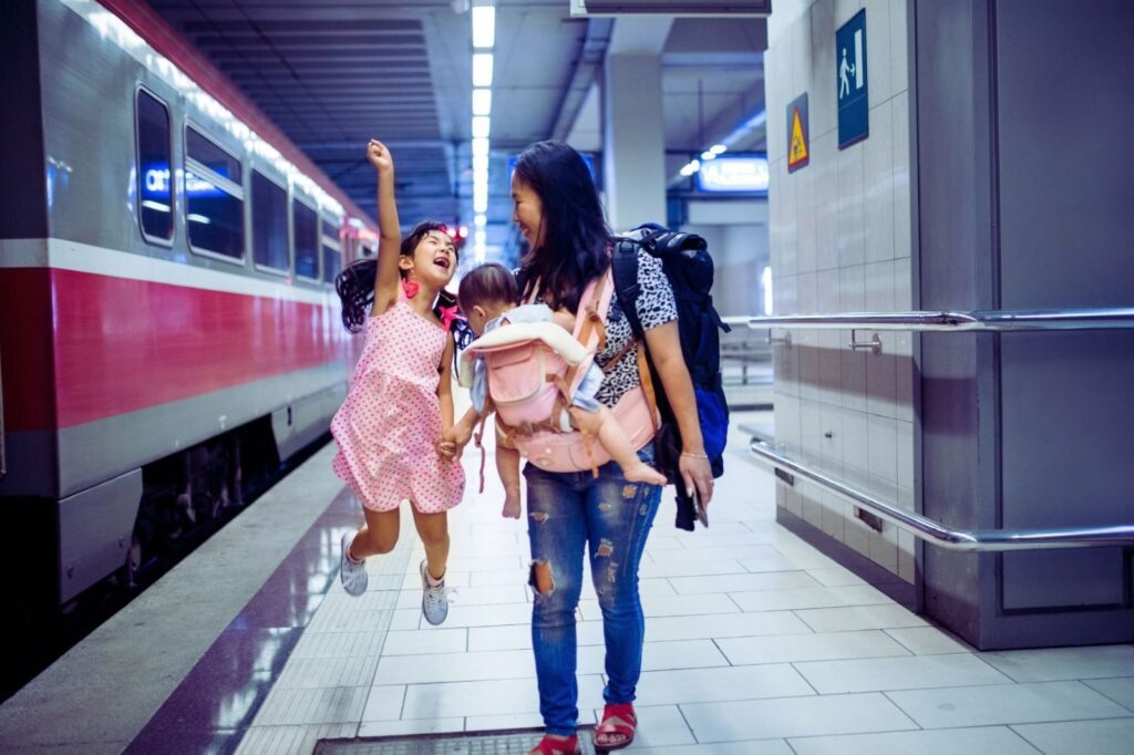 woman with children by train